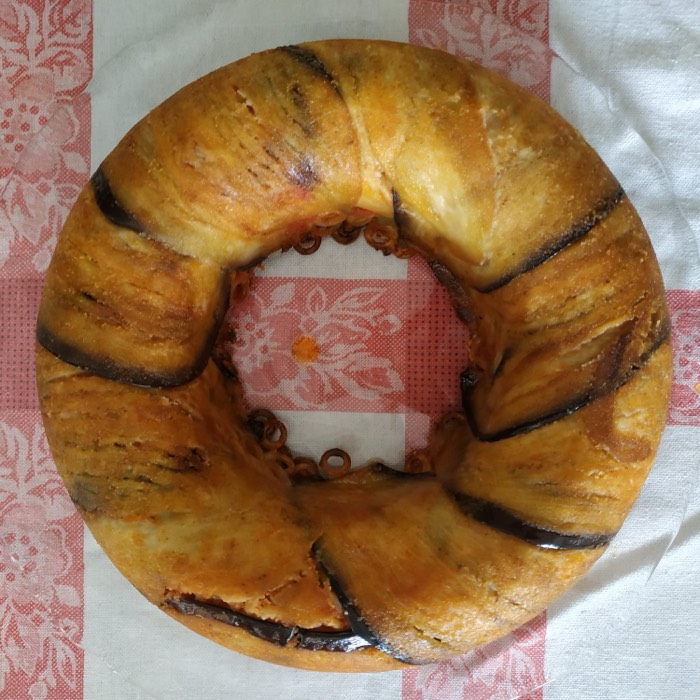 A filled bread ring wrapped in aubergine