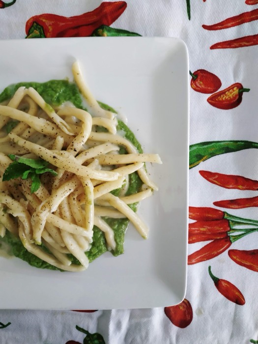 Handmade fusilli on a bed of basil pesto