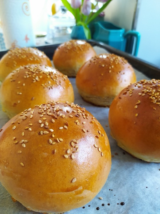 Golden sesame brioche buns fresh from the oven
