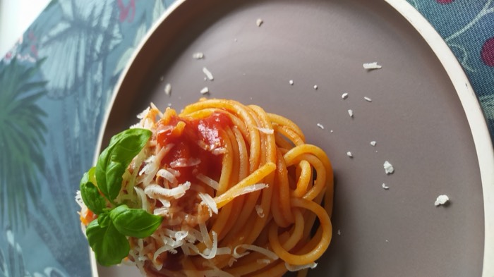 Spaghetti al pomodoro with basil and grated cheese