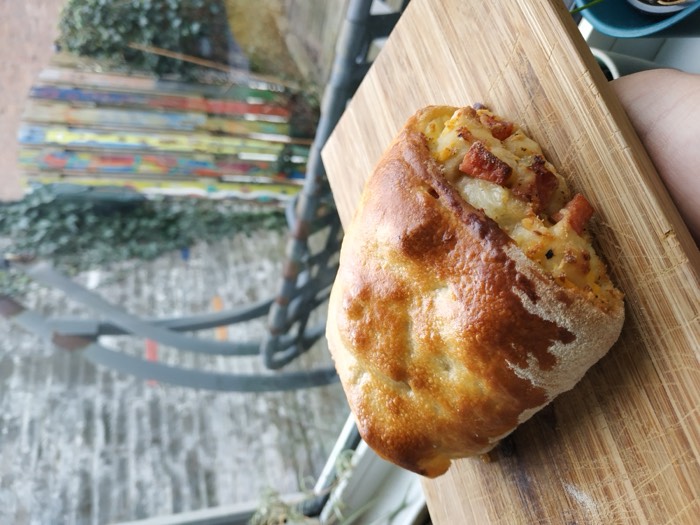 A stuffed bread loaf on a wooden board